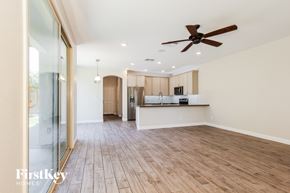 Goodyear house for rent - A spacious room with wooden flooring and a ceiling fan.