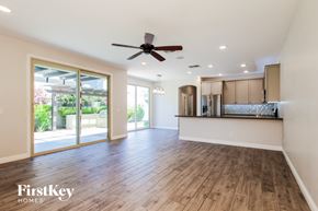 Goodyear house for rent - A spacious room with wooden flooring and a ceiling fan.