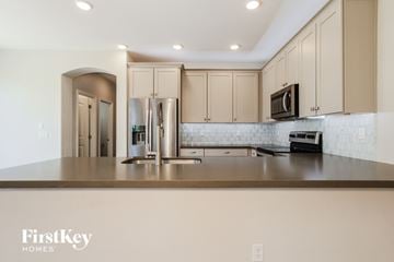 Goodyear house for rent - A kitchen with a black microwave on top of a counter.