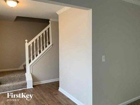 Lithonia house for rent - a stairway in a house with a white railing and a white wall