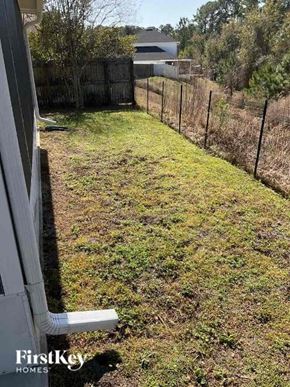 Middleburg house for rent - A backyard with a fence and a grassy area.