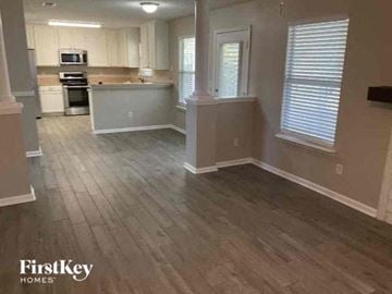 Middleburg house for rent - A kitchen with wooden floors and white cabinets.