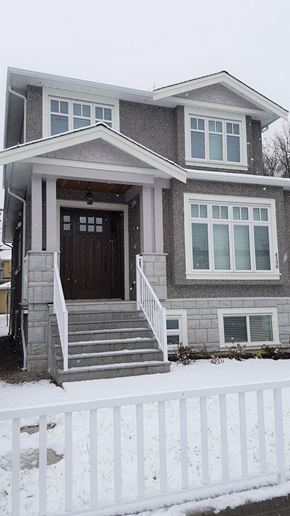 Vancouver apartment for rent - A house with a brown door and a white fence.