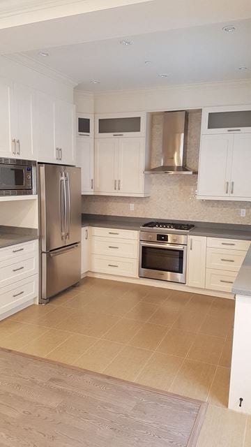 Vancouver apartment for rent - A kitchen with white cabinets and stainless steel appliances.