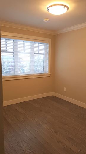 Vancouver apartment for rent - A room with a window and wooden flooring.