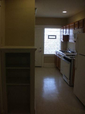 St. Louis apartment for rent - A kitchen with a white refrigerator and white oven.