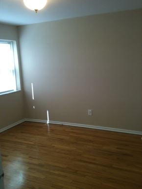 St. Louis apartment for rent - A room with a wooden floor and a window.