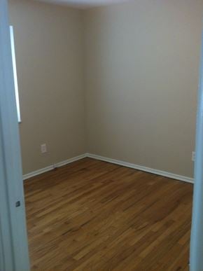 St. Louis apartment for rent - A room with wooden flooring and a white wall.