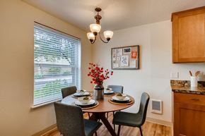 Clackamas apartment for rent - Apartments near Happy Valley for Rent - Sunnyside Village - Dining Room off of Kitchen with Large Window, White Walls, and Wood Flooring