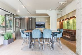 Portland apartment for rent - Apartments in Downtown Portland, OR for Rent - Linc 301 - Recreation Lounge with Tables, Chairs, Curtain Separator, TV Area, Plants, and Large Windows.
