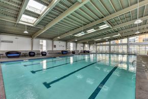 Bellevue apartment for rent - Olympic Size Indoor Swimming Pool with Round  Black/Blue Chairs and Saftey Railing