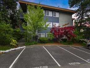 Kenmore apartment for rent - A parking lot in front of a building with a sign that says "VISITOR".
