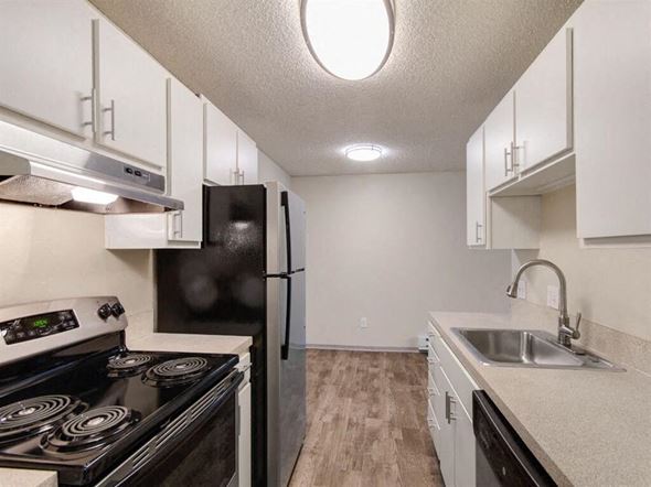 Kenmore apartment for rent - A kitchen with a black stove and a black refrigerator.