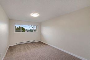 Kenmore apartment for rent - A room with a window and a carpeted floor.