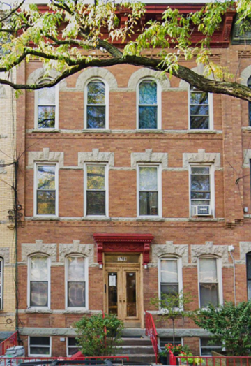 Ridgewood apartment for rent - A red brick building with a wooden door and windows.