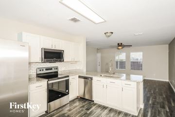 Princeton house for rent - a kitchen with white cabinets and stainless steel appliances