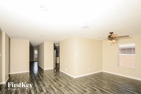 Princeton house for rent - a living room with wood floors and a ceiling fan