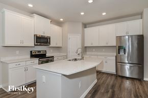 Palmetto house for rent - a white kitchen with stainless steel appliances and white counter tops