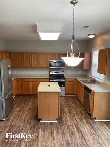 Huntersville house for rent - a kitchen with wood flooring and stainless steel appliances