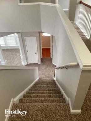 Huntersville house for rent - a staircase with a carpeted floor and a white door