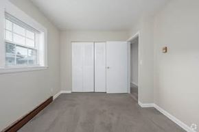 Gainesville apartment for rent - A room with a grey carpet and white walls.