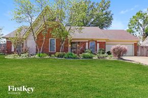 Bartlett house for rent - A brick house with a green lawn in front.