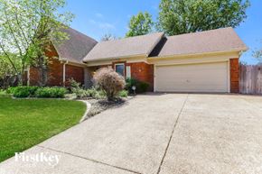 Bartlett house for rent - A brick house with a garage door is for sale.