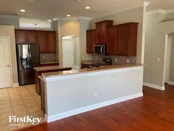 Jacksonville house for rent - A kitchen with wooden cabinets and a white island.