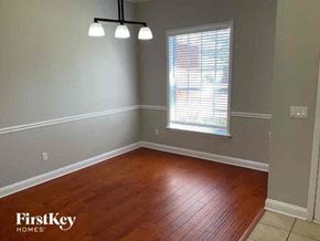 Jacksonville house for rent - A room with wooden flooring and a window with blinds.