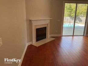 Jacksonville house for rent - A room with a fireplace and wooden floors.