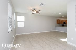 Mesa house for rent - A spacious room with a ceiling fan and tiled floor.