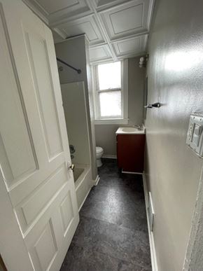 St. Louis apartment for rent - A bathroom with a toilet, sink, and window.