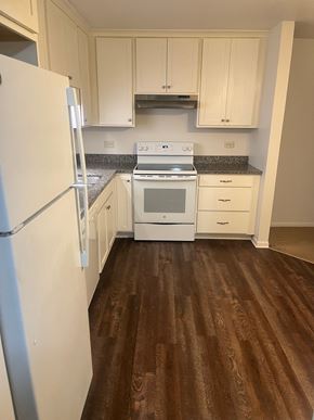 Lisle apartment for rent - A kitchen with a white fridge and white appliances.