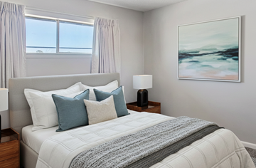 Tulsa apartment for rent - A bedroom with a large bed and a painting on the wall.