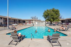 Tulsa apartment for rent - A group of people are enjoying a sunny day at the pool.