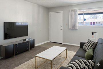 Tulsa apartment for rent - A living room with a grey couch and a white coffee table.