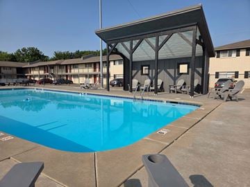 Tulsa apartment for rent - A large swimming pool with a pavilion in the background.
