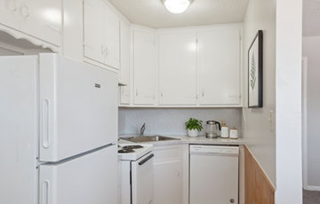 Tulsa apartment for rent - A white fridge in a kitchen with a stove and dishwasher.
