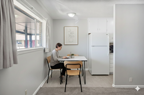 Tulsa apartment for rent - A man is sitting at a table in a kitchen.