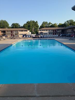 Tulsa apartment for rent - A large blue swimming pool with no people in it.