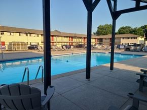 Tulsa apartment for rent - A pool with a chair and a pole in the foreground.