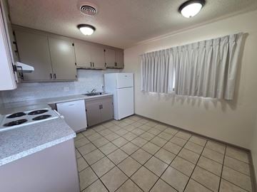 Tulsa apartment for rent - A kitchen with white appliances and cabinets.