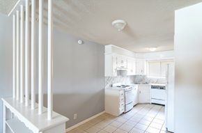 Tulsa apartment for rent - A white kitchen with a white fridge, stove, and dishwasher.