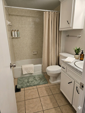Tulsa apartment for rent - A bathroom with a toilet, sink, and shower.