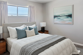 Tulsa apartment for rent - A bedroom with a large bed and a painting on the wall.