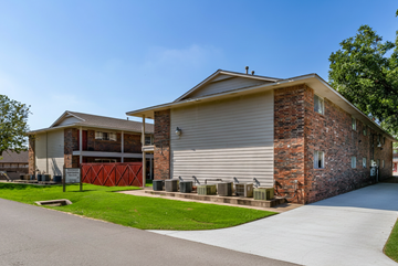 Tulsa apartment for rent - A two-story house with a garage and a driveway.