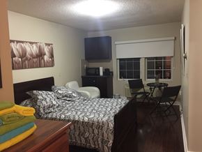 Toronto apartment for rent - a bedroom with a bed and a table and chairs