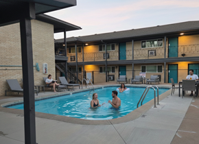Tulsa apartment for rent - A group of people are enjoying a swim in a pool at a resort.