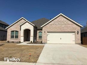 Grand Prairie house for rent - A brick house with a garage door that says "FirstKey Homes".