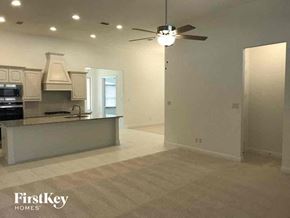 Grand Prairie house for rent - A spacious kitchen with a bar area and a ceiling fan.